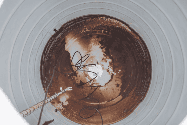 Water tank before cleaning - full of sediment and algae